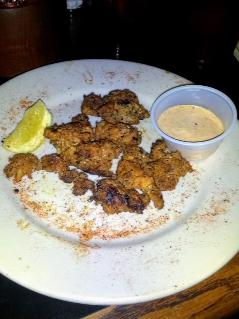 Cajun-style alligator served on a plate with spices. 