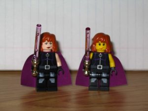 Two Lego minfigures representing Star Wars Expanded Universe character Mara Jade, including her signature purple lightsaber.