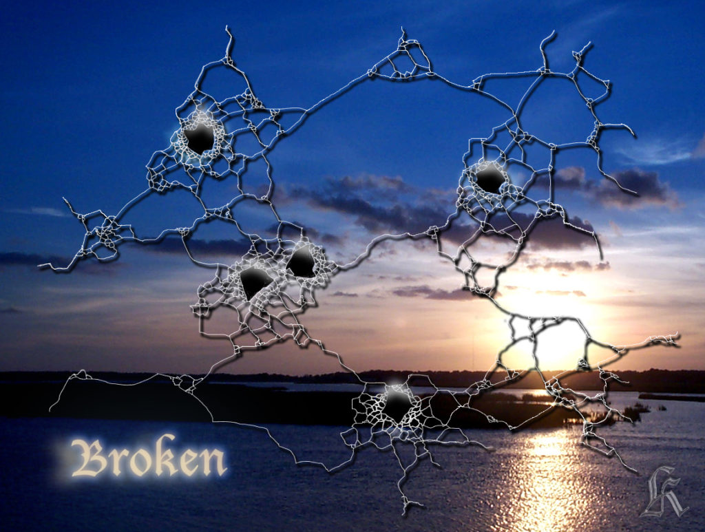 Bullet holes shot through a computer screen displaying a peaceful sunset scene.