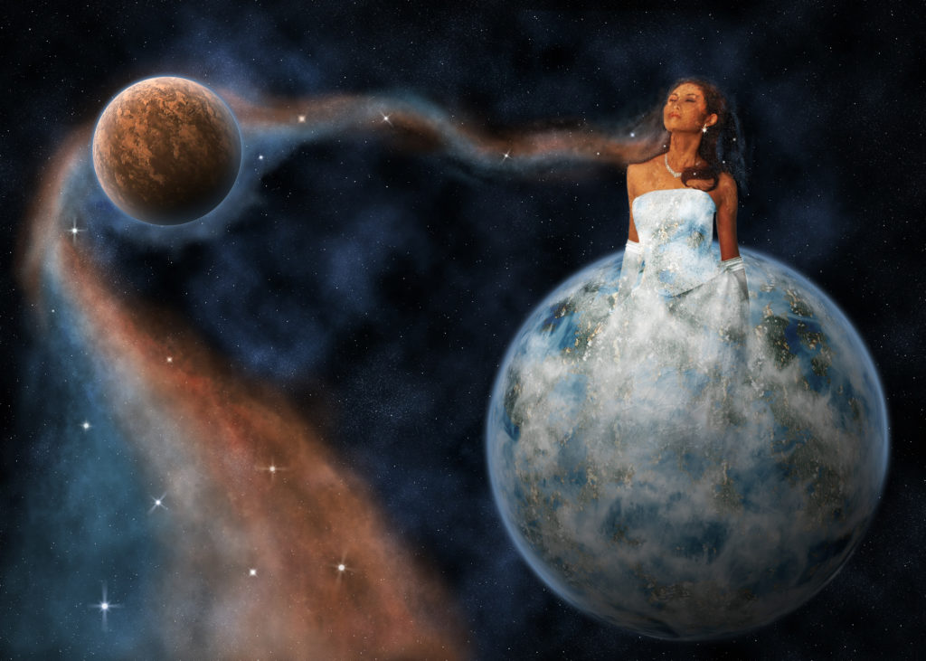 A girl with skin mirroring a desert planet emerges with a dress mirroring a water planet. 